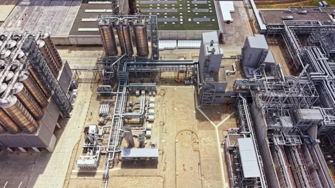 View of a large industrial facility with storage tanks and processing equipment Stock Footage 344201253