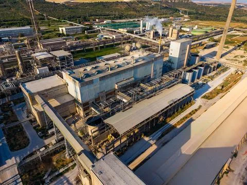 A view of a large industrial site with multiple factories, equipment, and mac Stock Photos
