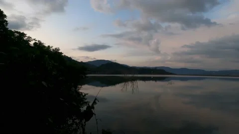 View of a large lake around which there is a walking route. Stock Footage 230078424