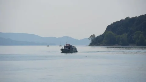 View of a Large Lake in the Haze With an Excursion Riverboat Passing By Stock Footage 245284856
