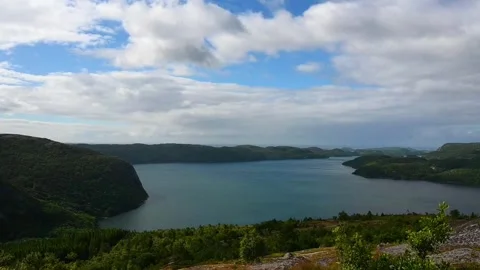 View of a large lake surrounded by hills under a cloudy sky in Norway durin.. Stock Footage 340212992
