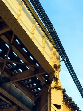 View of a large metal bridge structure with support beams and cables agains.. Stock Photos