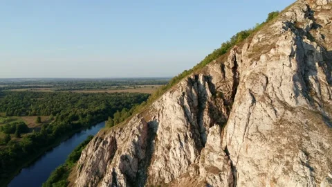 View of the large mountain range and river in the valley. Trees along the banks Stock Footage 158531684