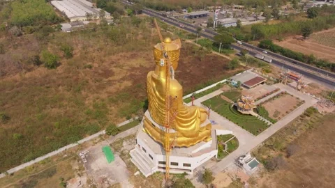 View of large religious monument under crane assembly Thailand Stock Footage 306759864