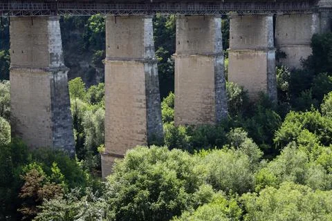 View of the large stone pillars supporting a bridge over a forested area on a Stock Photos