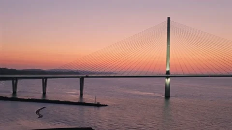 A view of a large three-tower cable-stayed bridge at sunrise Stock Footage 161334221