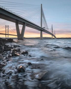 A view of a large three-tower cable-stayed bridge at sunrise Stock Photos