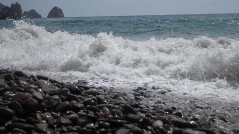 View of large waves in slow motion. Waves rise and break on the rocky shore. Stock Footage 334120492