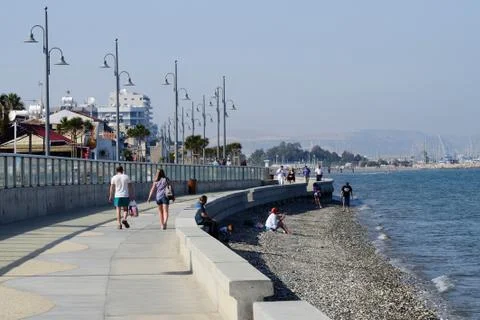 View of Larnaca seafront with palm trees , pedestrians and beach,Cyprus Stock Photos