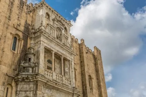View of lateral facade of the gothic building of Coimbra Cathedral Stock Photos