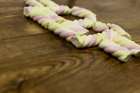 View from left below at drawn the symbol with marshmallows. Stock Photos