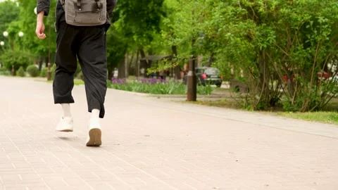 View of the legs of a guy running along a city alley. Slow Motion Stock Footage 279742371