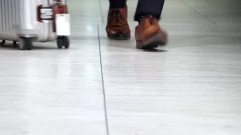 View on legs of people walking with suitcases in a terminal Stock Footage 342520090