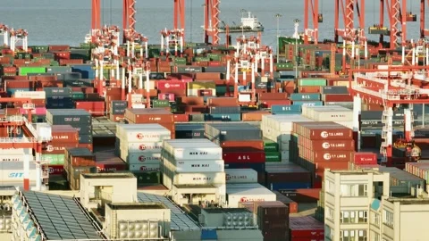 View lifting from container stacks to red crane booms at Guangzhou Port Stock Footage 346446624