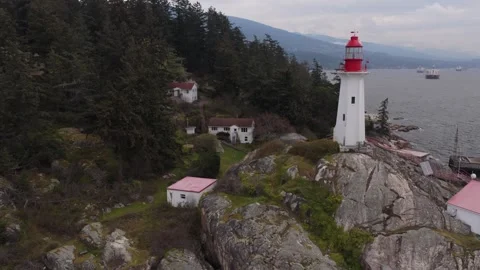 View of light house on rocks from high Stock Footage 333645080