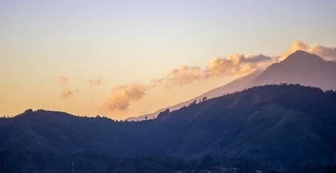 The view of the light of the sunset behind the mountain Stock Photos