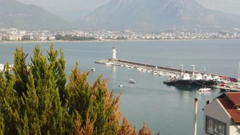 View of lighthouse and harbour with small boats in Alanya, Antalya, Turkey Stock Footage 233002970
