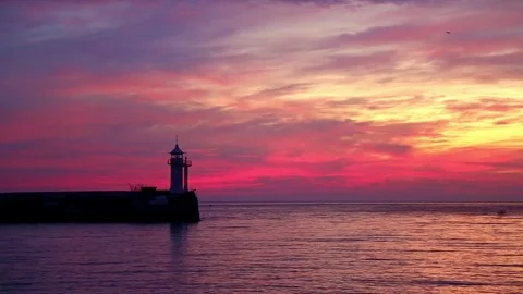 View of the lighthouse at dawn standing on the coast Stock Footage 84809242