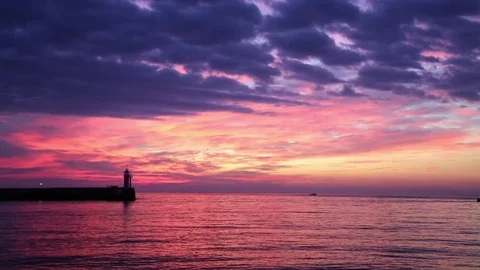 View of the lighthouse at dawn standing on the coast Stock Footage 84809372