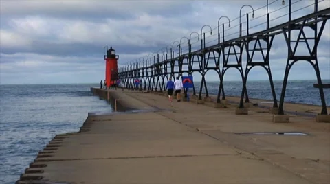View of a Lighthouse At End Of Pier Stock Footage 56586671