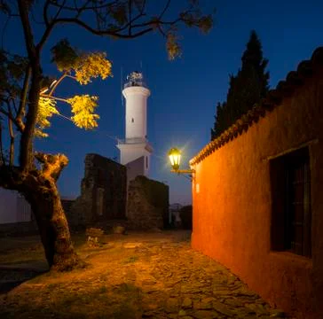 View of lighthouse at night from cobbled street, Barrio Historico (Old Quarte Stock Photos