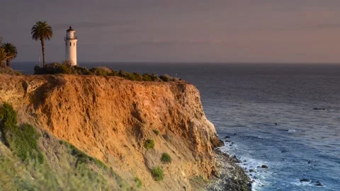 View of Lighthouse by the Ocean and Cliffs - Sunset - California - Palm Tree Stock Footage 138897983