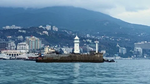View of the lighthouse standing on the coast in Yalta, Crimea Stock Footage 84808062