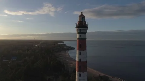 View of lighthouse, stands next to the sea near the coastline, helps the ships Stock Footage 75464927