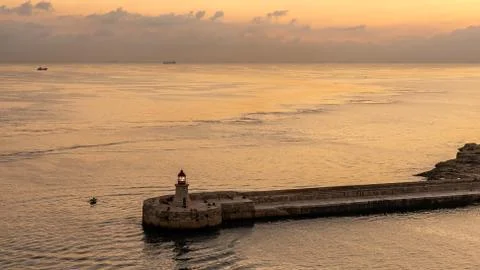 View on lighthouse of valetta at sunset, malta Stock Photos