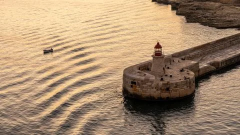 View on lighthouse of valetta at sunset, malta Stock Photos