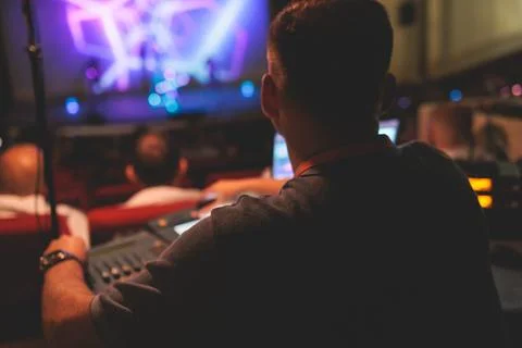 View of lighting technician operator working on mixing console workplace du.. Stock Photos