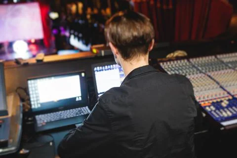 View of lighting technician operator working on mixing console workplace du.. Fotos de archivo