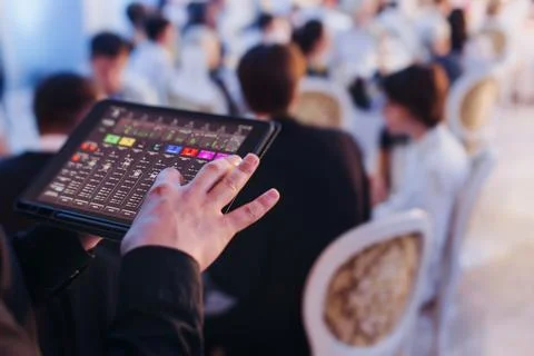 View of lighting technician with tablet, operator controlling sound and lig.. Stock Photos