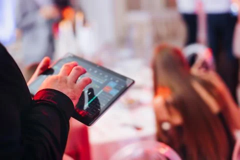 View of lighting technician with tablet, operator controlling sound and lig.. Stock Photos