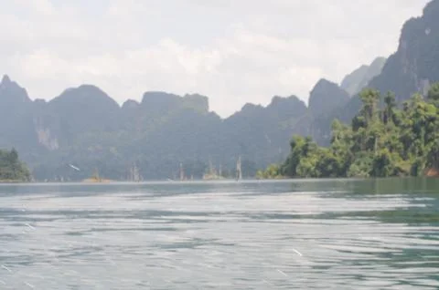 View of limestone cliffs from the water through the mist, Thailand Stock Photos