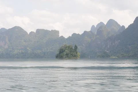 View of limestone cliffs from the water through the mist, Thailand Stock Photos