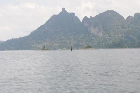 View of limestone cliffs from the water through the mist, Thailand Stock Photos