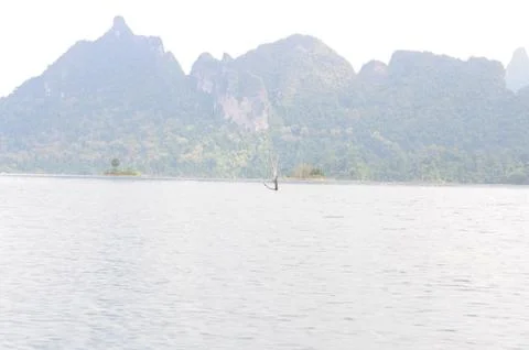 View of limestone cliffs from the water through the mist, Thailand Stock Photos