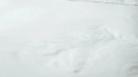 View to linen white bed while a man housekeeping cleaning bed make up bed i.. Stock Footage 286314241