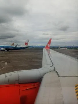 A view of Lion air's wing during its preparation to take off Stock Photos