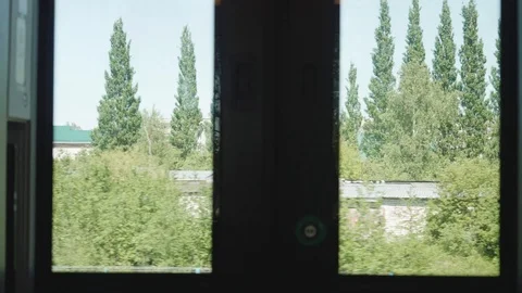 View of little town from window of moving train. Slow motion view. Stock Footage 115069391