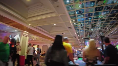 View of lively casino interior with glowing ceiling lights and people enjoying Stock Footage 332018030