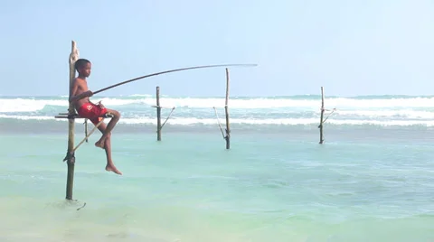 View of local boy on a fishing pole in t, Stock Video