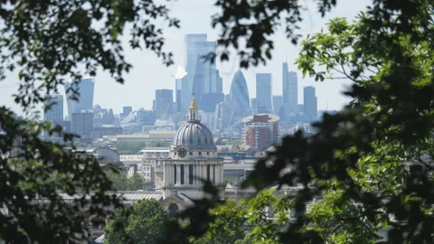 A view of the London city through tree branches and leaves. Video stock 155746549