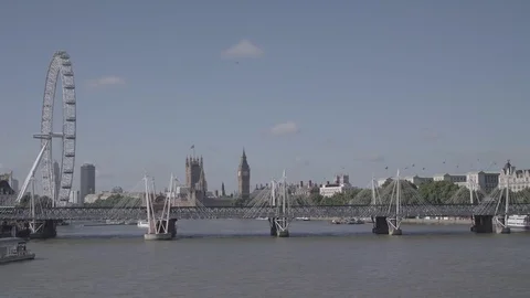 View of London eye, river Thames and Parliament Building from Waterloo bridge Stock Footage