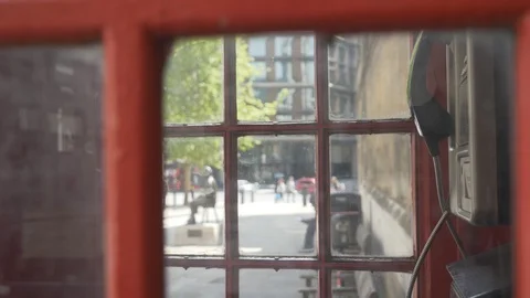 View of London from inside a red telephone booth. Video stock 107945040