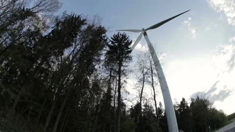 View on lonely electric windmill on the edge of forest. View from down to up. Stock Footage 107684340