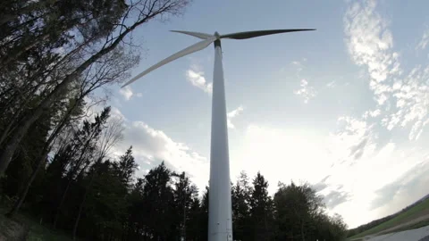View on lonely electric windmill on the edge of forest. View from down to up. Stock Footage 107686160