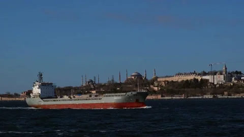 View of the long cargo ship and historical mosque on the sea. Stock Footage 148424893