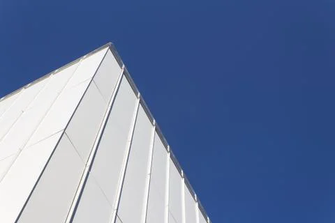 View looking up at corner of white generic building facade Stock Photos